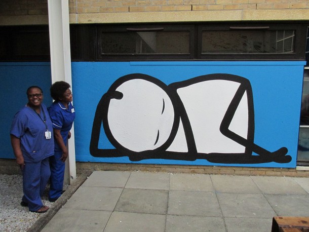 Sleeping Baby NHS nurses look over a baby sleeping in the courtyard of the hospital. Homerton Hospital, Hackney, London, 2015.